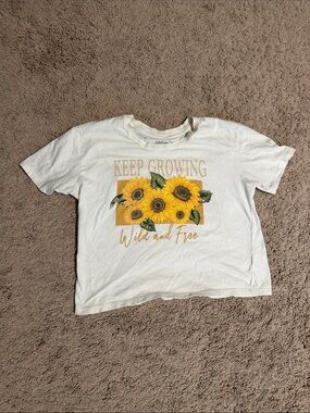 Rebellious One White Tee with Yellow Sunflower Graphic and Green Leaves